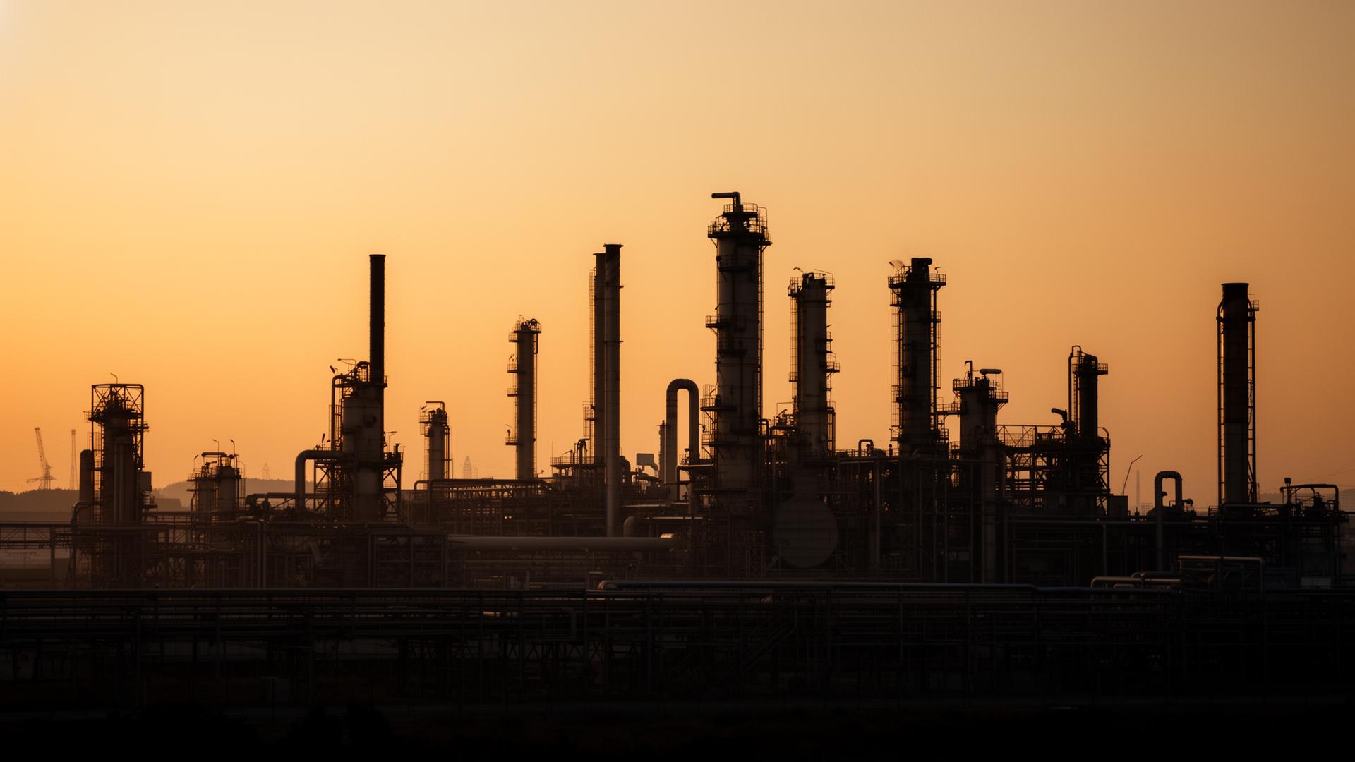 Industrial refinery silhouette at golden hour
